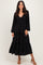 woman wearing a black long sleeve maxi dress with a tie-front and tiered skirt
