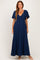 woman wearing a navy blue maxi dress with short flutter sleeves and a fitted bodice