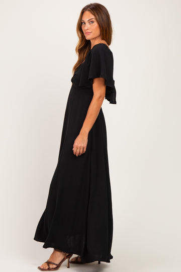 woman wearing a black maxi dress with ruffled sleeves and a flattering silhouette