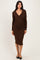 woman wearing a brown long sleeve wrap dress with ruched detailing and a fitted silhouette