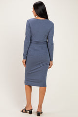 woman wearing a blue long sleeve bodycon dress with a ribbed texture, showing the back view
