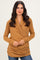 woman wearing a warm mustard long sleeve wrap top with gathered sides and a casual fit