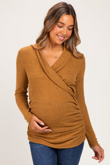 woman wearing a mustard yellow long sleeve maternity top with wrap style and ruching, showing her baby bump