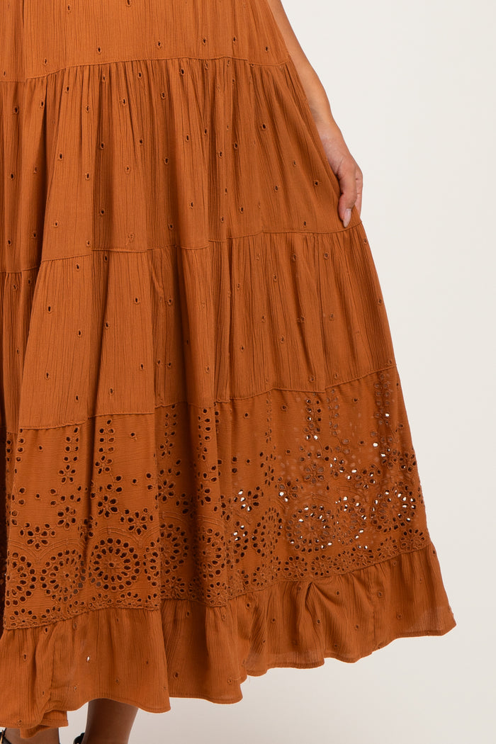 maternity wear rust colored tiered maxi dress with eyelet detailing and ruffled hem