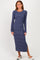 woman wearing a navy blue striped long sleeve maxi dress with a side slit and round neckline