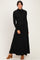 woman wearing a black long sleeve ribbed maxi dress with a mock neck and a flowy silhouette