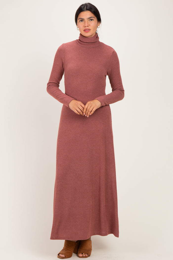 woman wearing a rust long sleeve turtleneck maxi dress with a ribbed texture and brown heeled shoes