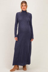 woman wearing a dark blue long sleeve ribbed maternity dress with a fitted silhouette and a visible baby bump