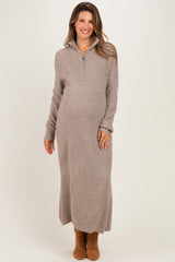 woman wearing a neutral ribbed maternity sweater dress with a half-zip and a visible baby bump
