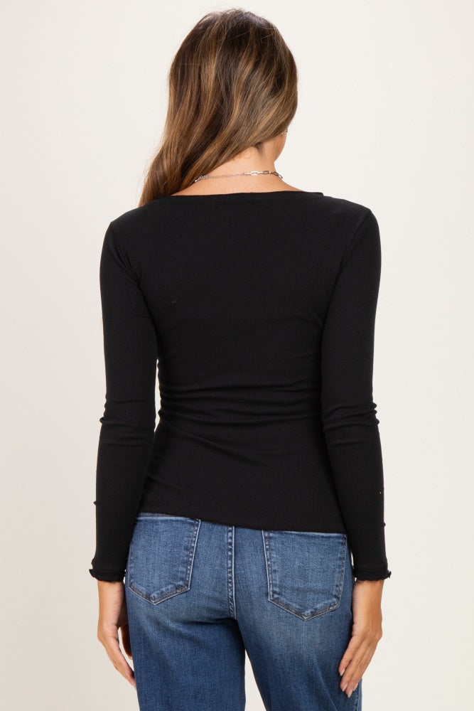 woman wearing a black long sleeve maternity top, showing the back view with a relaxed fit