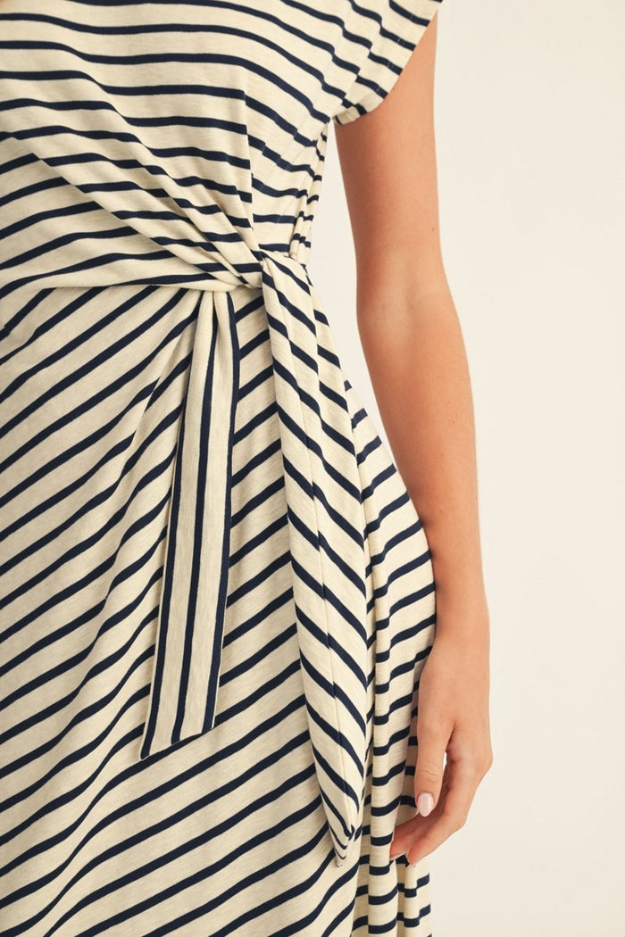 woman wearing a striped midi dress with a tied waist detail