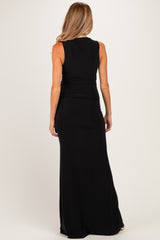 woman wearing a black sleeveless maxi dress, viewed from the back, showcasing a fitted silhouette, maternity wear