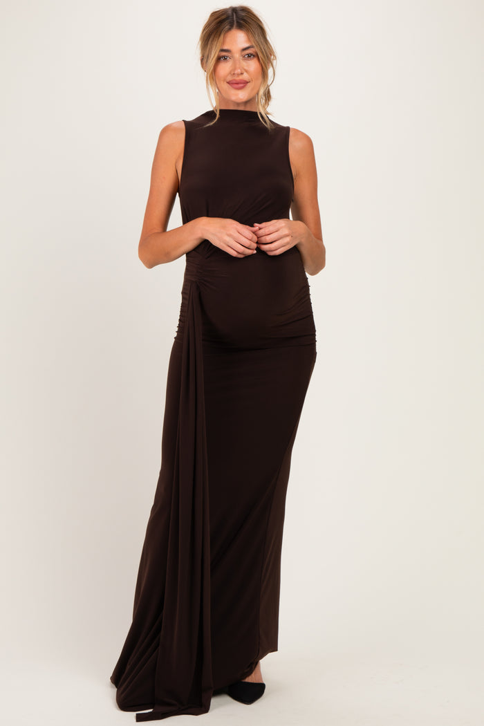 woman wearing a dark brown sleeveless maternity gown with side ruching and a visible baby bump