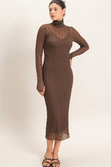 woman wearing a chocolate brown long sleeve fitted dress with a high neckline and textured ribbed design