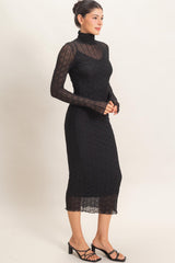 woman wearing a black long sleeve sheer dress with a turtleneck and form-fitting silhouette