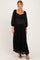 woman wearing a black lace maternity maxi dress with a tiered hem and balloon sleeves, showing her baby bump