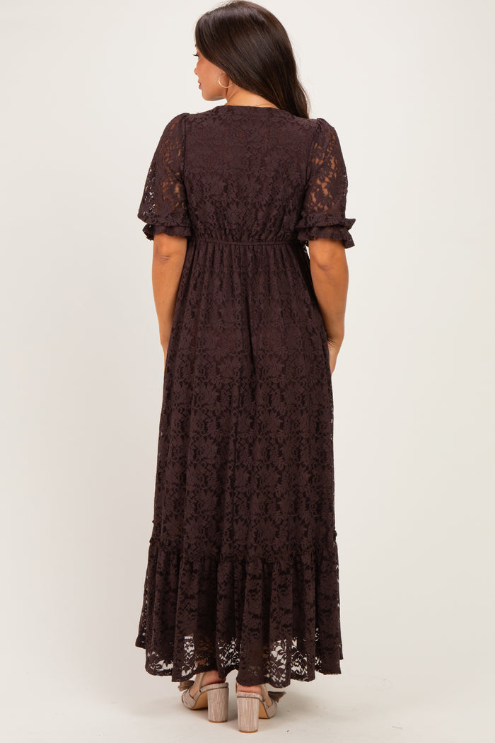woman wearing a dark brown lace maternity maxi dress with short sleeves and a fitted waist, showing her baby bump from behind