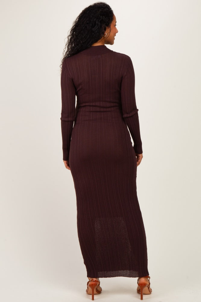 woman wearing a dark brown long sleeve maternity dress with a fitted silhouette and a maxi length, showing her baby bump