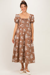 woman wearing a brown floral print maternity dress with puff sleeves and a square neckline, showing her baby bump