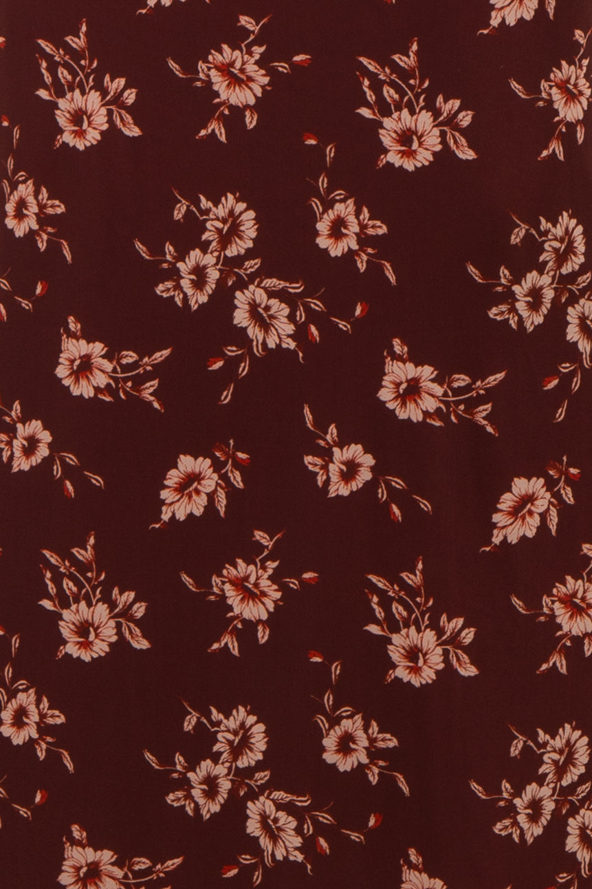 burgundy floral fabric with peach flowers and green leaves throughout