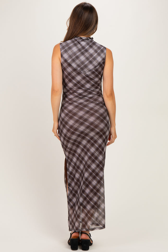 woman wearing a brown plaid maternity maxi dress with a high slit, showing a pregnant baby bump from the back