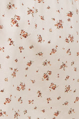 floral print fabric with small pink and brown flowers on a cream background