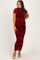 woman wearing a burgundy floral lace maternity dress that hugs her curves and showcases her baby bump