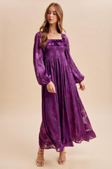 woman wearing a purple floral maxi dress with puff sleeves and a smocked bodice