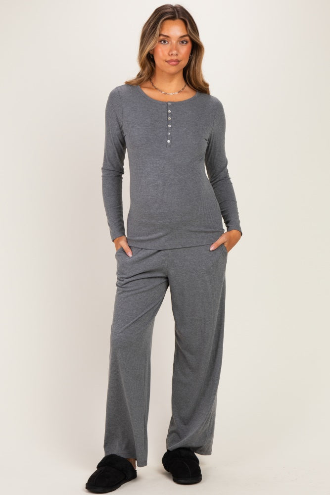 woman wearing a gray maternity loungewear set with a long sleeve henley top and wide-leg pants, model with a baby bump