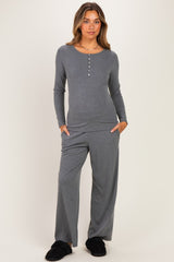 woman wearing a gray maternity loungewear set with a long sleeve henley top and wide-leg pants, model with a baby bump