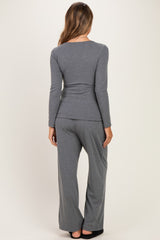 woman wearing a gray long sleeve maternity top and matching pants, showing a comfortable fit from the back