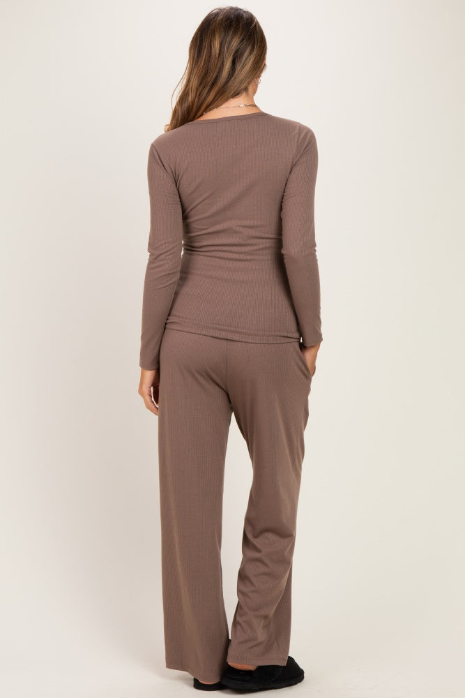 woman wearing a brown long sleeve maternity top and matching pants, viewed from the back