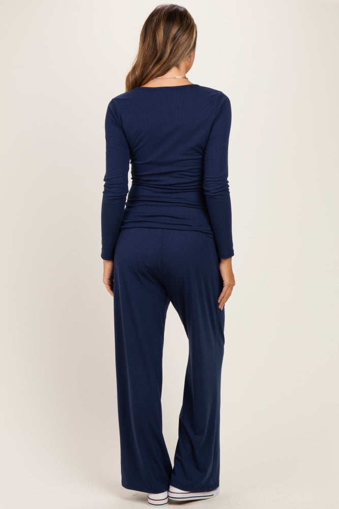 woman wearing a navy blue long sleeve maternity top and matching wide-leg pants, viewed from the back