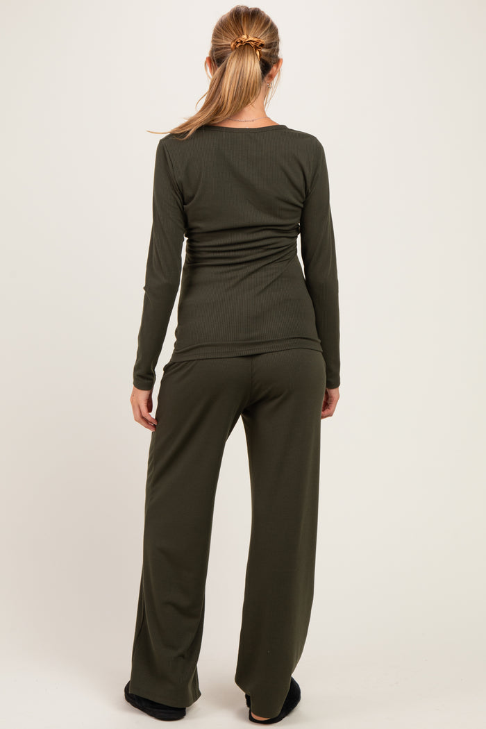 woman wearing an olive green long sleeve maternity top and matching maternity pants, viewed from the back