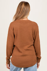 woman wearing a brown textured maternity sweater with a relaxed fit and long sleeves, viewed from the back