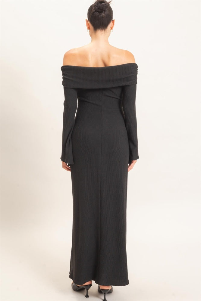 woman wearing a black off-the-shoulder ribbed maxi dress from the back with long sleeves and a fitted silhouette