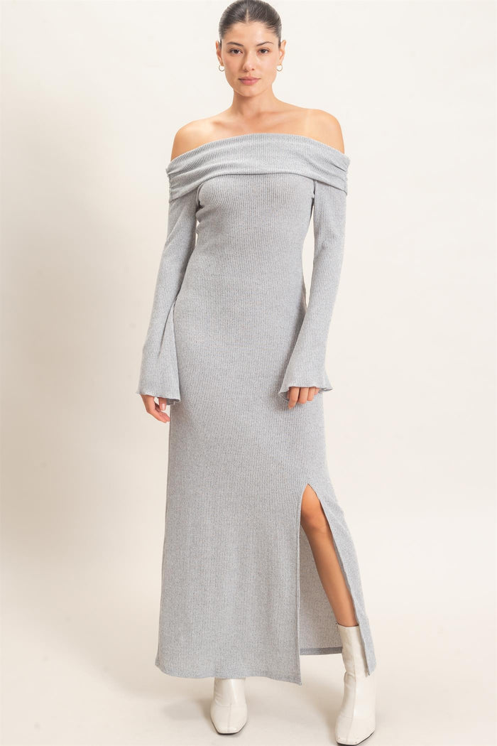 woman wearing a gray off-the-shoulder ribbed maxi dress with long sleeves and a side slit
