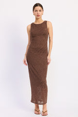 woman wearing a sleeveless brown lace maxi dress with a fitted silhouette and a round neckline