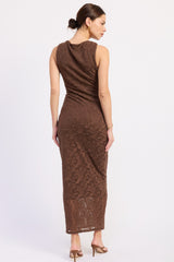woman wearing a brown lace sleeveless maxi dress with a fitted silhouette and scoop neck, facing away from the camera
