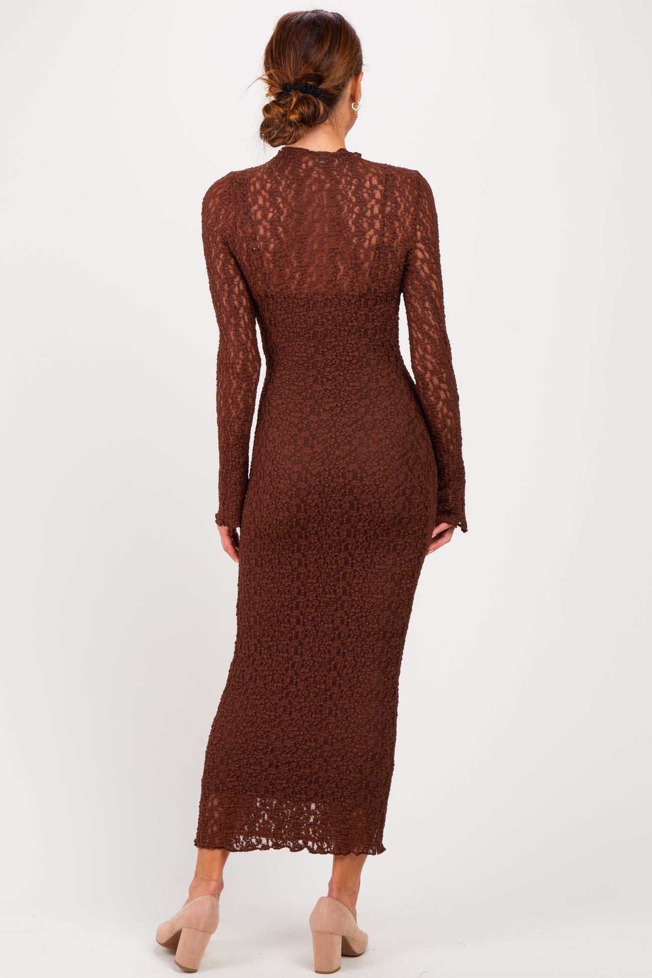 woman wearing a brown long sleeve midi dress with a lace overlay and fitted silhouette, view from the back