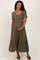 woman wearing a green striped maternity dress with short sleeves and a tiered skirt, holding her baby bump