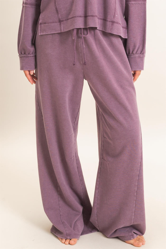 woman wearing purple wide leg lounge pants with a drawstring waist and a relaxed fit
