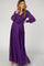 woman wearing a purple long sleeve maternity dress with a tie waist and flowing skirt, featuring a visible baby bump