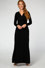 woman wearing a black long sleeve maxi dress with a wrap bodice and pockets