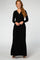 woman wearing a black long sleeve maxi dress with a wrap bodice and pockets