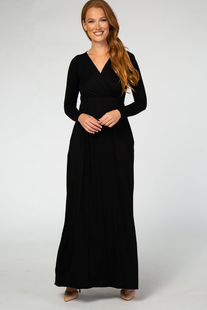 woman wearing a black long sleeve maxi dress with a wrap bodice and pockets