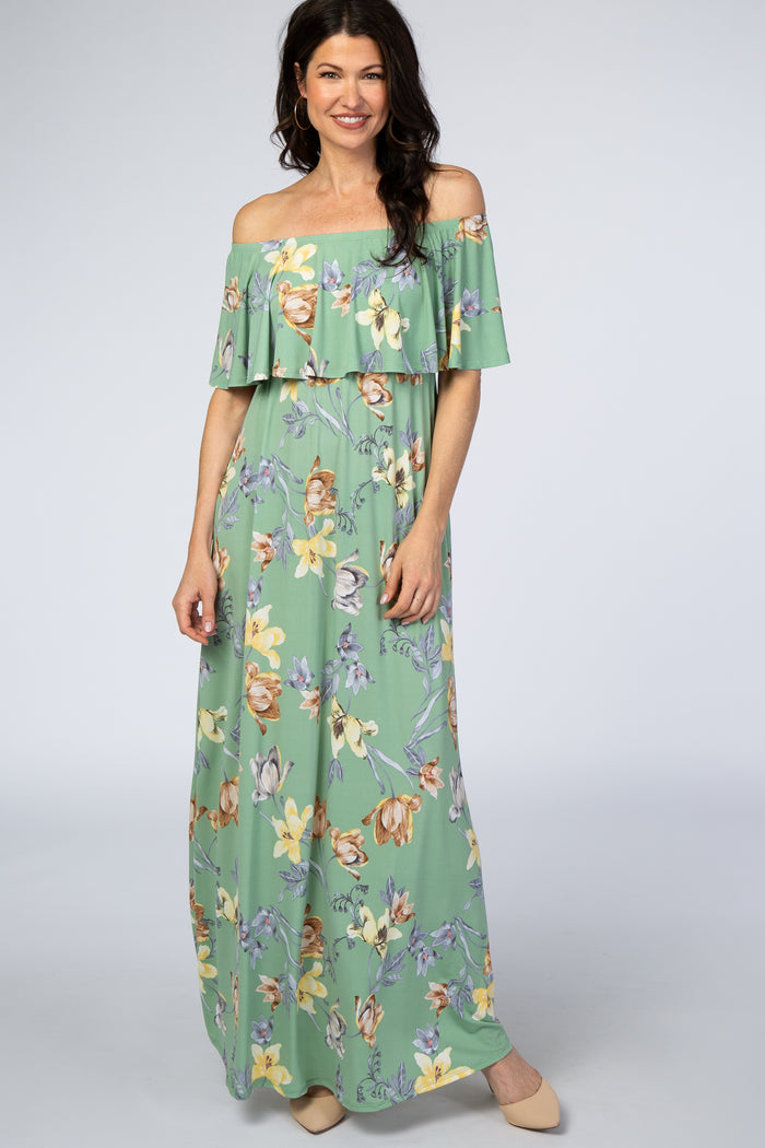 woman wearing a light green off-the-shoulder maxi dress with floral print and ruffle detailing