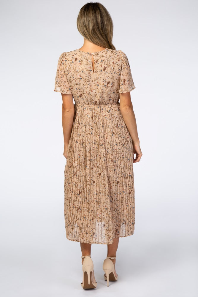 woman wearing a back view of a floral pleated midi dress with short sleeves and a keyhole detail at the neckline
