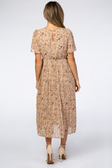 woman wearing a back view of a floral pleated midi dress with short sleeves and a keyhole detail at the neckline