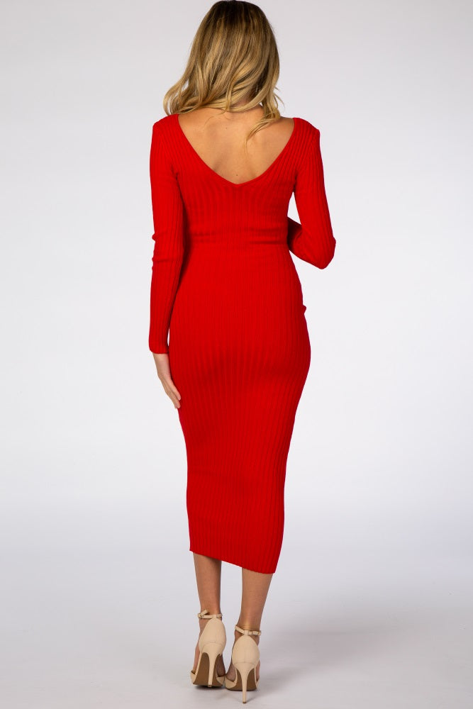 woman wearing a red ribbed maternity dress with a v-back and long sleeves